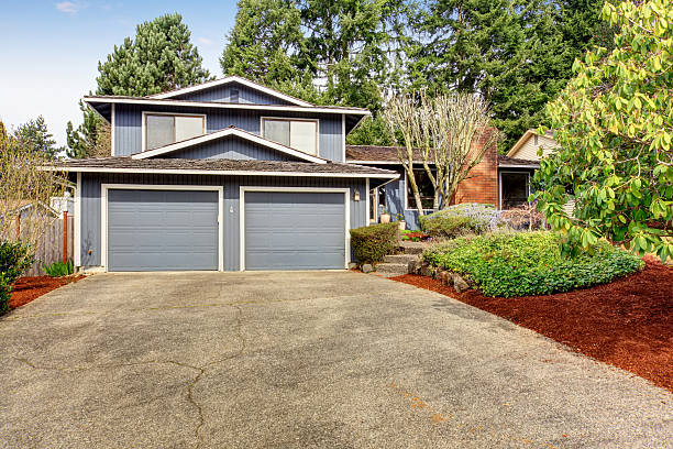istock Beautiful blue home with large yard containing grass and soil. 481067420