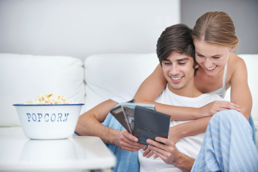 A young couple choosing a movie to watch at home
