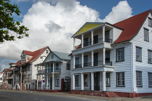 Paramaribo, Suriname - March 17, 2013: Row of colonial buildings along Waterkant street.. Some of the buildings serve as various surinam departments and the who;e area with wooden buildings is a Unesco Word heritage site.