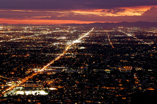 Phoenix, Arizona after sunset with a stormy sky on the horizon.