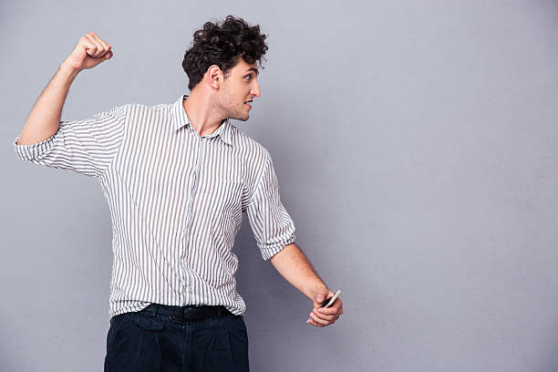 istock Angry young man clenching his fist 481072494