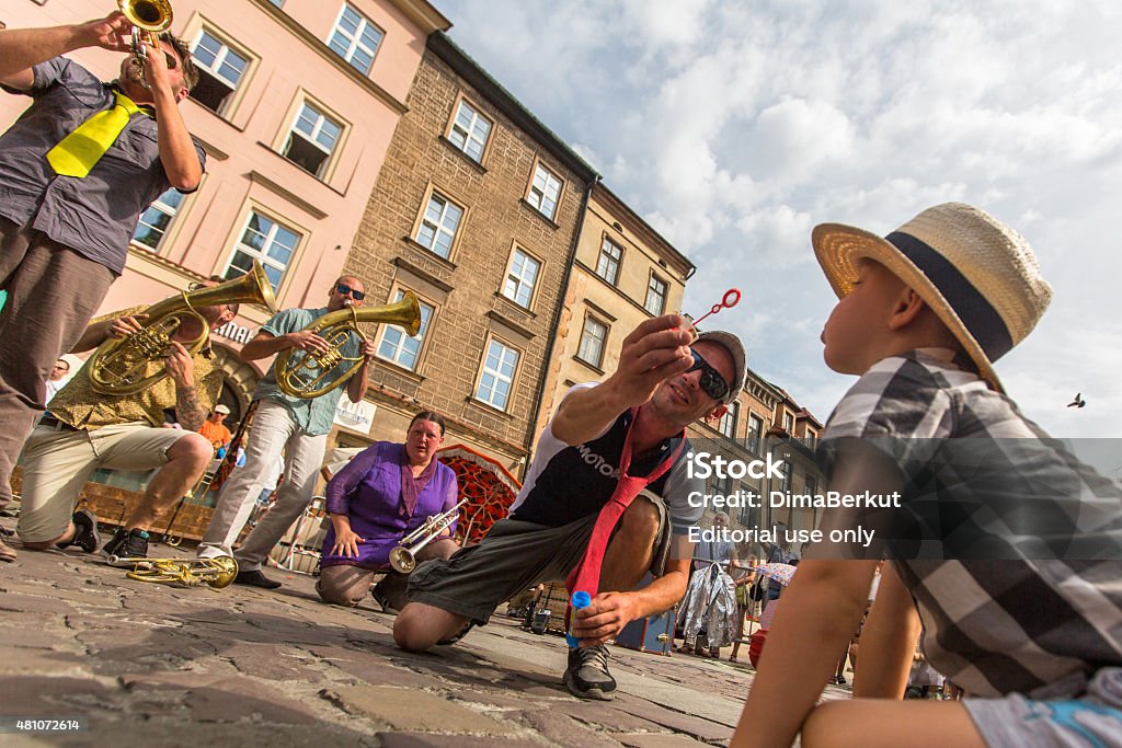 International Festival of Street Theatres in Krakow Krakow, Poland - July 12, 2015: Participants at the annually (July 9-12) 28th International Festival of Street Theatres - Orchestre International du Vetex (Belgium/France) in the Main Square of Krakow. 2015 Stock Photo