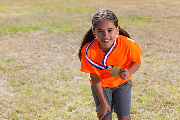 Mixed race girl (Caucasian / Latin, 11 years) with award.