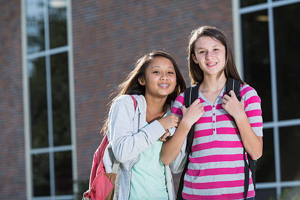 istock Girls standing outside school 481073101