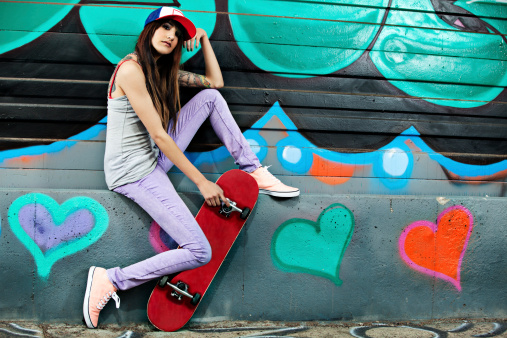 A young woman with skateboard.