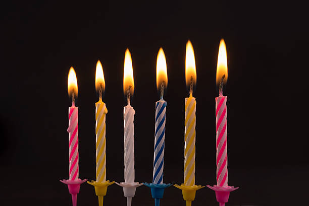 istock Burning birthday candles on black background 481074277