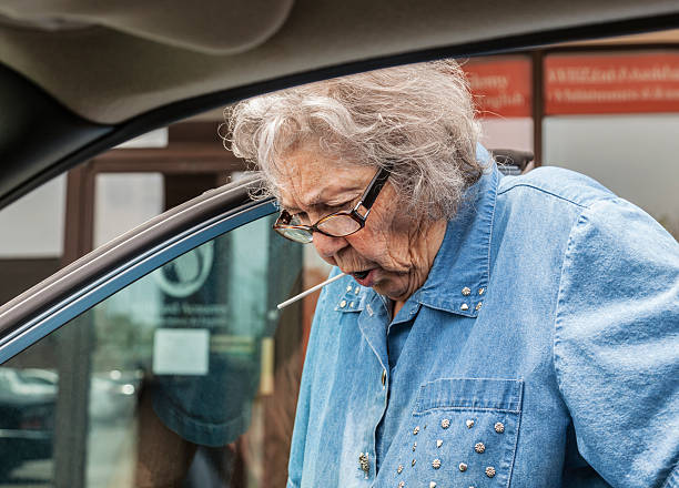 istock Grandma Sucking Lollypop While Getting Into Car 481074281