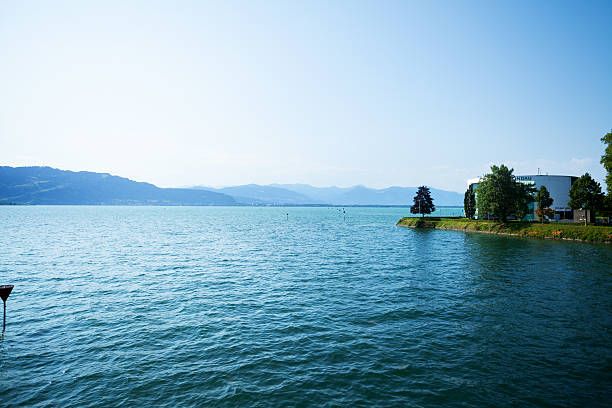 Lindau, Germany - July 11, 2015: Panoramic view of Swiss alps, lake Bodensee and island Lindau with casino at midsummer sunshine.