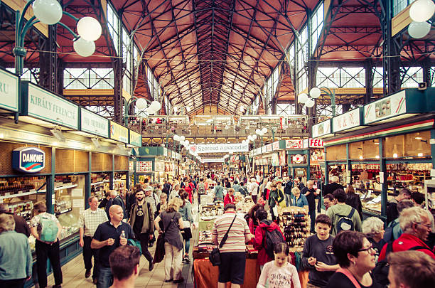 Central Market Hall (Nagy Vasarcsarnok) - Budapest, Hungary Budapest, Hungary - May 26, 2015: Shoppers and tourists wander the main market hall in Budapest, Hungary. market hall stock pictures, royalty-free photos & images