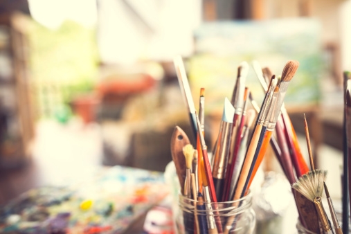 Painter brushes in studio artist's