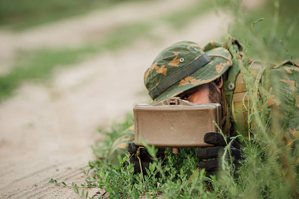 Horizontal photo of soldier using automatic weapon