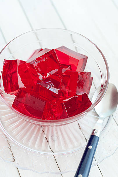 istock Red jelly cubes in glass bowl with spoon 481078808