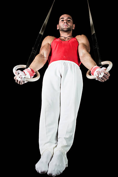 istock Young man on gymnastics rings. 481079525