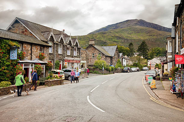 Beddgelert Wales UK Beddgelert, UK  - September 15, 2011: Tourists and locals walk and window shop in the quaint Welsh village of Beddgelert in the heart of the Snowdonia mountains. welsh culture stock pictures, royalty-free photos & images