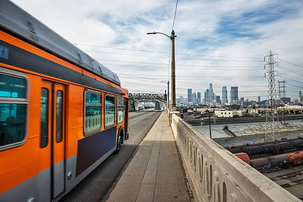 Over the bridge Bus moving across the 6th street bridge in LA. sixth street bridge stock pictures, royalty-free photos & images