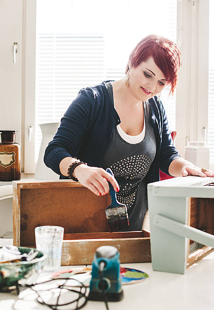 istock woman at home with paint brush 481082651