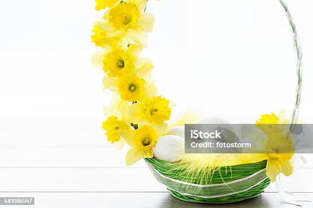 Easter Eggs In A Basket With Spring Daffodils Stock Photo - Download Image Now - Basket, Copy Space, Daffodil