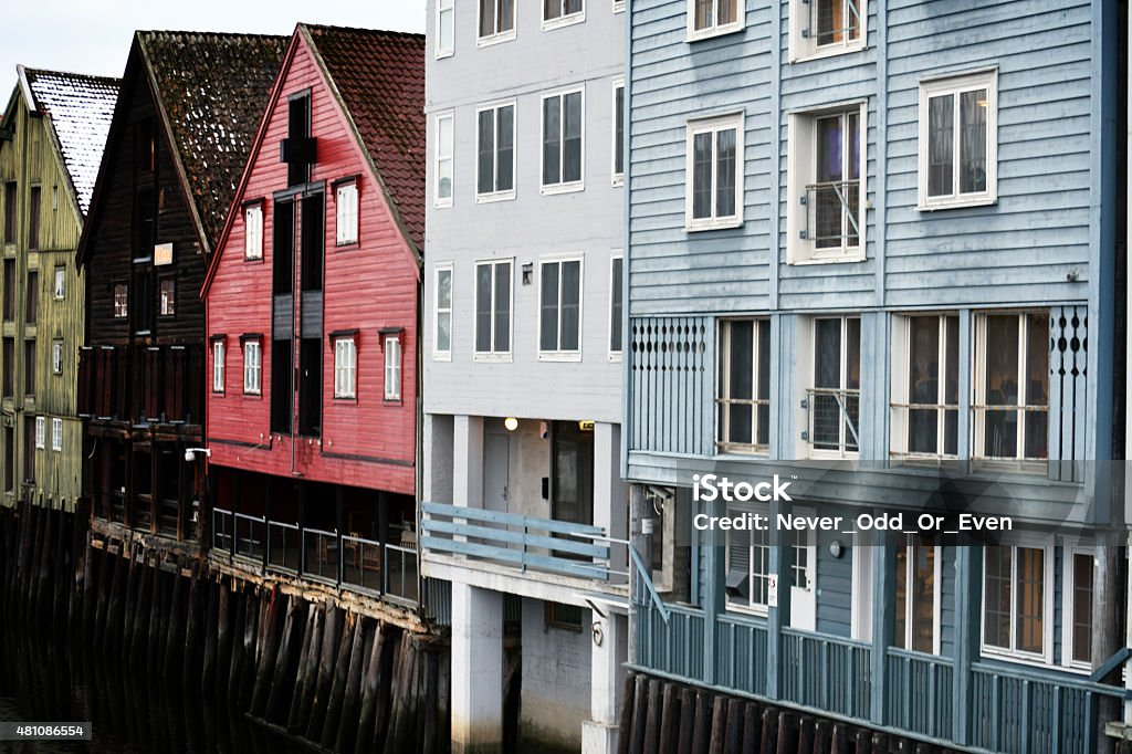 Old wooden houses during white nights in Norway The picture was taken actually around 2 a.m. during white nights in Trondheim. It is a picture of old wooden houses at one of the three bridges in Trondheim, Norway. The picture was taken with Nikon D3300 and has been processed as to make it more colorful. 2015 Stock Photo