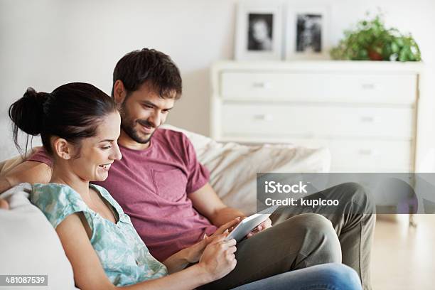 Showing Him Something She Saw Online Stock Photo - Download Image Now - Adult, Adults Only, Affectionate