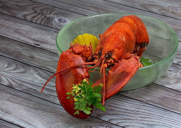 istock Red lobster in bowl on wooden background 481087547