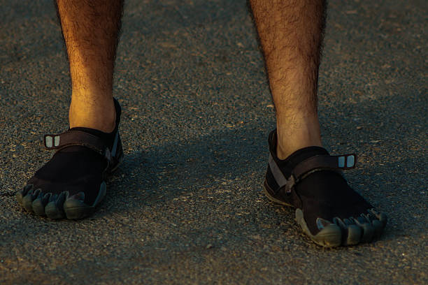 istock Barefoot runner in black toe shoes also known as fivefingers 481089986