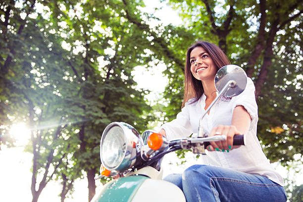 istock woman riding vintage scooter 481090792