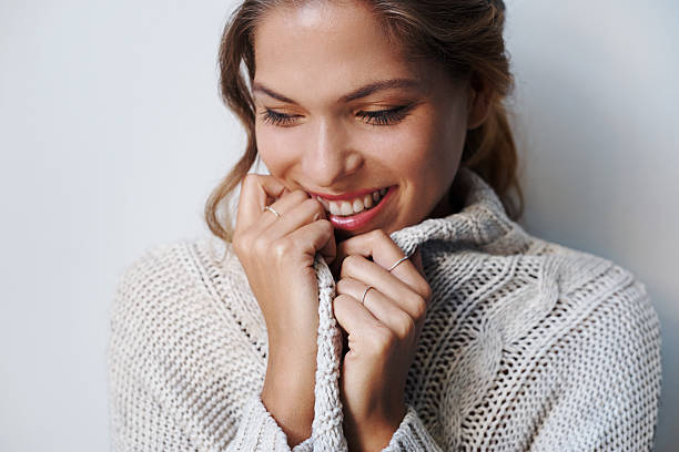 The season for snuggly sweaters Cropped shot of beautiful young woman wearing a sweater indoorshttp://195.154.178.81/DATA/i_collage/pu/shoots/805301.jpg cardigan sweater stock pictures, royalty-free photos & images