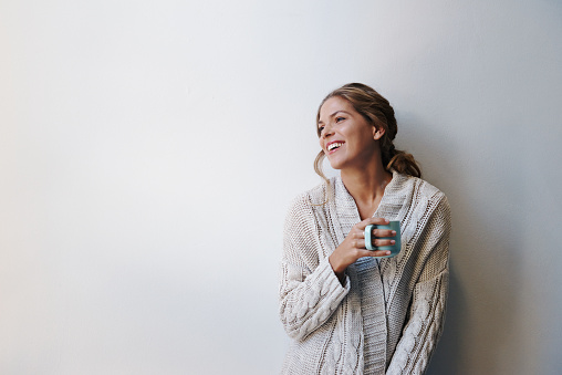 A beautiful young woman wearing a sweater having a cup of coffee indoorshttp://195.154.178.81/DATA/i_collage/pu/shoots/805301.jpg