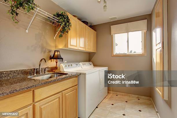 Traditional Laundry Room With Nice Counters And Washer Dryer Com Stock Photo - Download Image Now