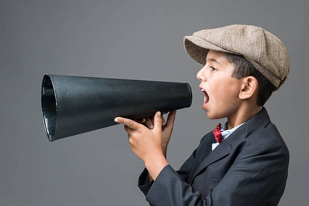 istock Little boy Shouting With Megaphone in front of gray background 481091916