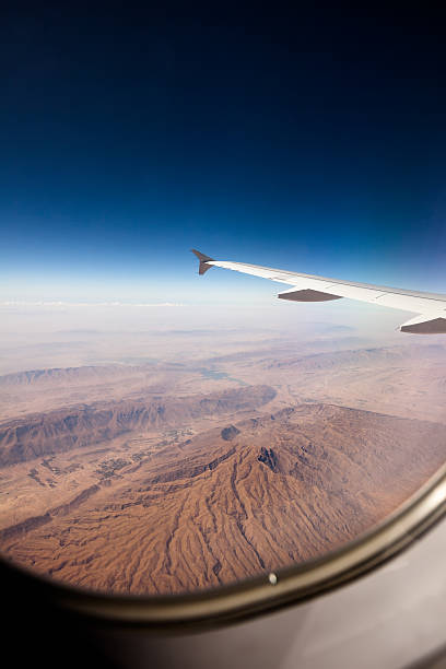 istock View at the earth from window of airplane 481092064