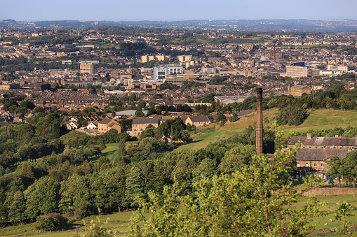 Bradford city centre - viewed from Clayton. Greenbelt land on the edge of the city of Bradford. Showing mills, houses and the city centre in the distance. 