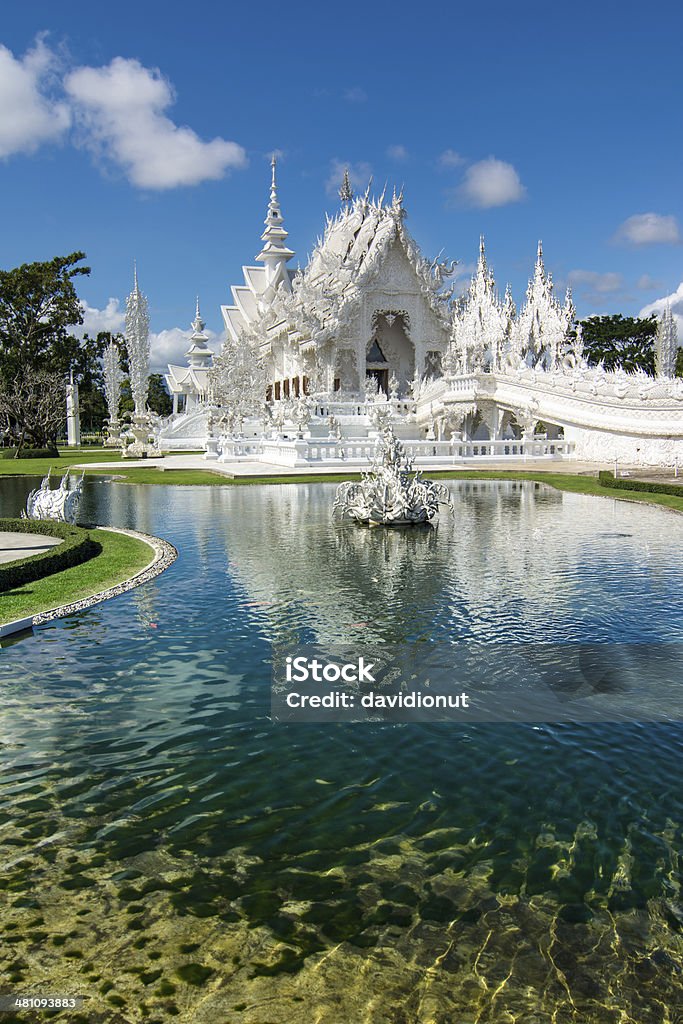 Wat Rong Khun (White Temple), Chiang Rai, Thailand Beautiful ornate white temple located in Chiang Rai northern Thailand. Wat Rong Khun (White Temple), is a contemporary unconventional Buddhist temple.Beautiful ornate white temple located in Chiang Rai northern Thailand. Wat Rong Khun (White Temple), is an unconventional Buddhist temple. Architecture Stock Photo