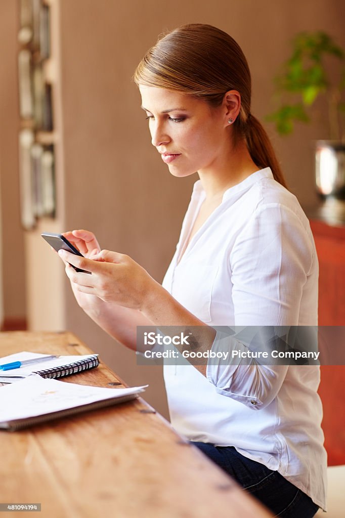 Self-employment is the way to go Shot of a young woman using her cellphone while working from homehttp://195.154.178.81/DATA/i_collage/pu/shoots/805292.jpg 2015 Stock Photo