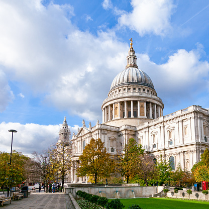 St. Paul's Cathedral in London between buildings, UK. This is Christopher Wren's masterpiece and one of London's top tourist attractions.