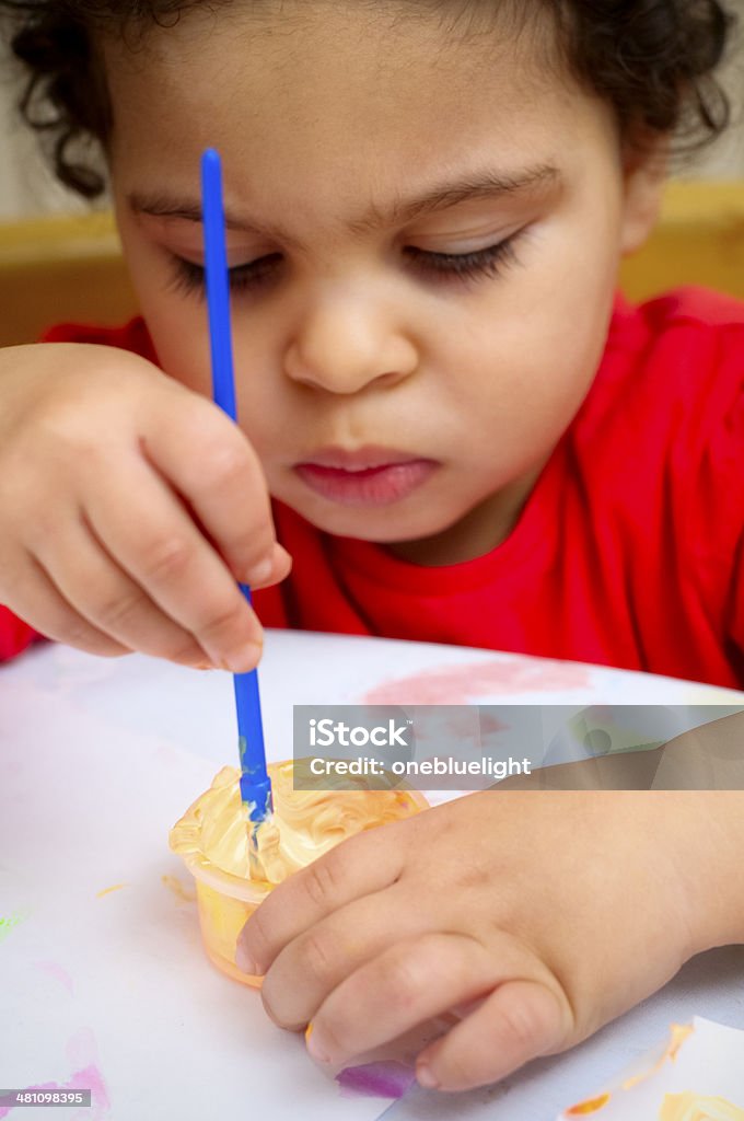 PEOPLE: Child (2-3)  Is Playing With Paint. Royalty free stock photo of toddler having fun with paint.Shot in Raw and post processed in Prophoto RGB. No sharpening applied. This file has a  18-23 Months Stock Photo