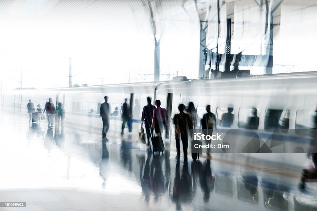 Unrecognizable, blurred passengers getting on a train blurred commuters getting on a train Boarding Stock Photo