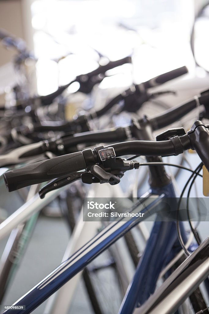 Bicycles for sale lined up in a bike shop. Bicycles lined up for sale in a bike shop. Aluminum Stock Photo