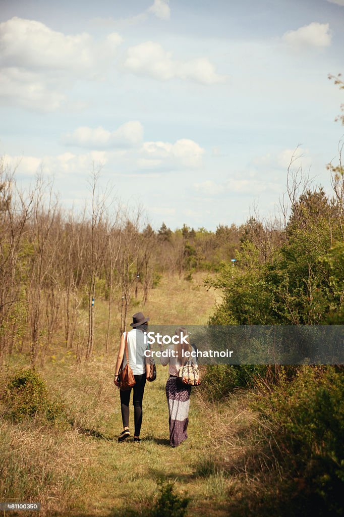 Enjoying a nature trip Two friends in hipster gypsy clothes, walking and enjoying the nature trip in the early Spring or Autumn time. Couple - Relationship Stock Photo