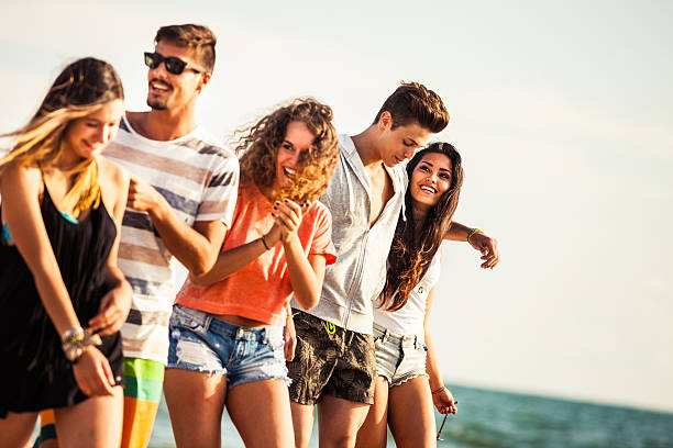 istock Friends having a walk on the beach 481100402