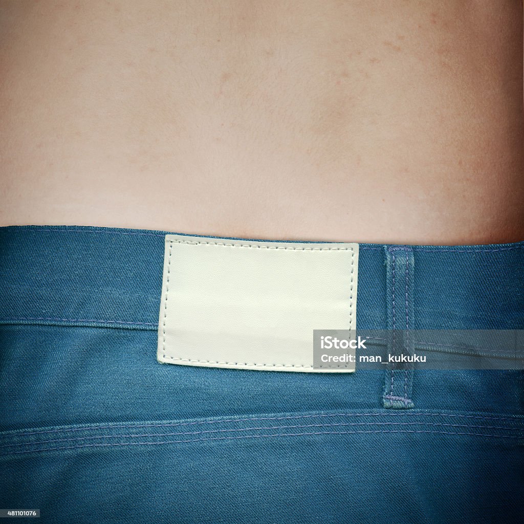 Blank leather label on jeans white blank leather label sewed on a blue jeans 2015 Stock Photo