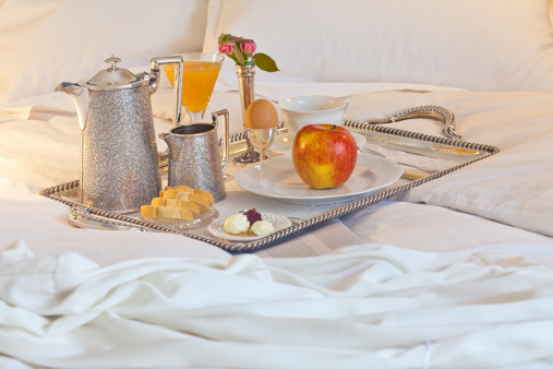 Elegant breakfast tray on a comfortable bed