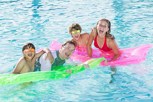 istock Family playing in swimming pool 481103141