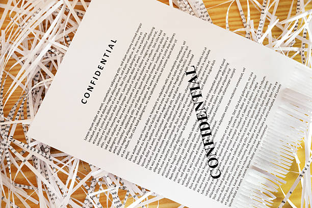 istock Confidential document on top of shreddered paper 481103407