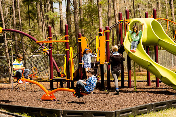 Elementary children play at school recess or park on playground.