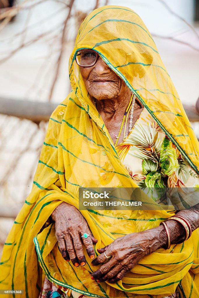 Indian senior woman Indian senior woman covered wit yellow veil in Rajastahn 2015 Stock Photo