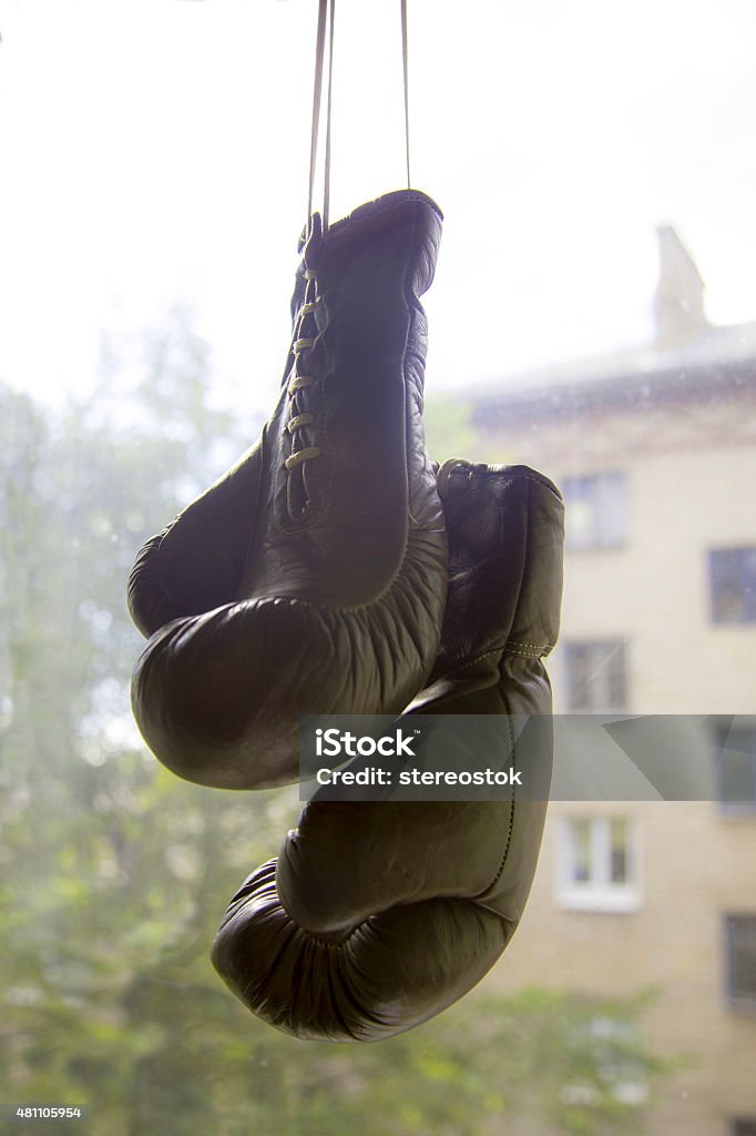 old boxing gloves on the background of the window 2015 Stock Photo