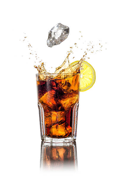 Long drink with ice cubes and splash A longdrink with ice cubes and splash cola photos stock pictures, royalty-free photos & images