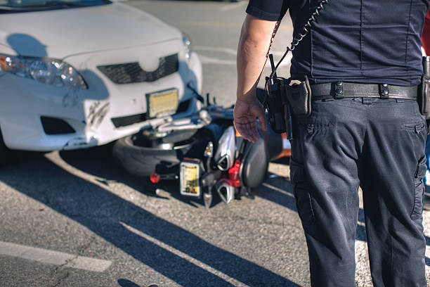 Accident Police office at scene of an accident between a car and motorcycle. misfortune stock pictures, royalty-free photos & images