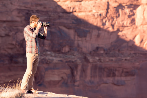 Young man hiking and taking photos in the American Southwest